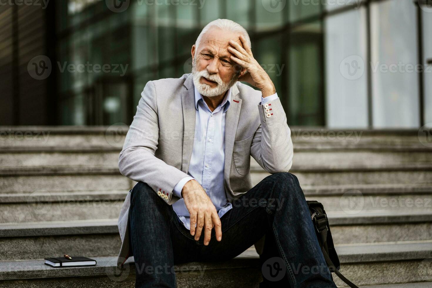 un irritato anziano uomo riposo su il le scale foto