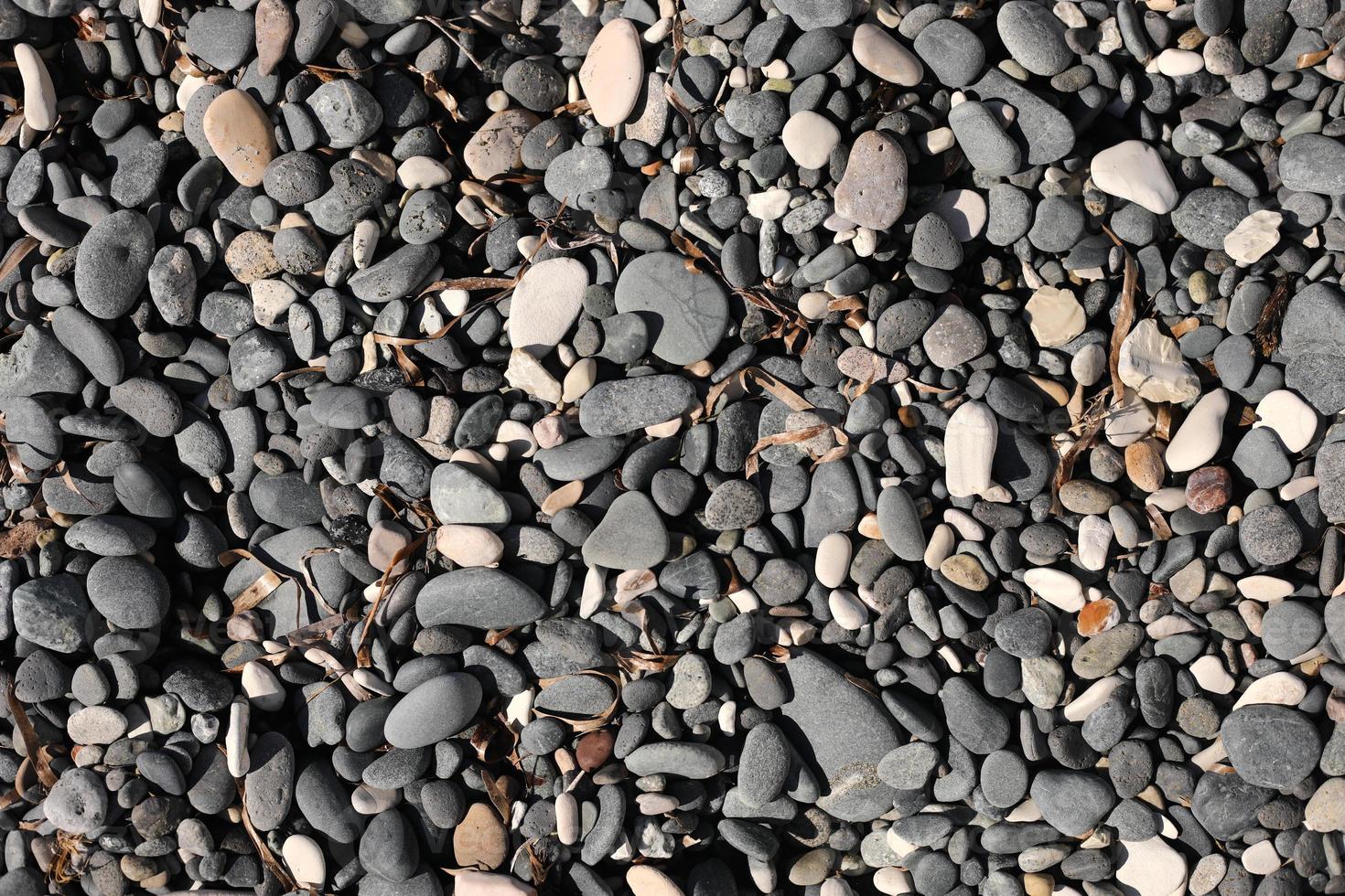 ciottoli sulla spiaggia come sfondo foto