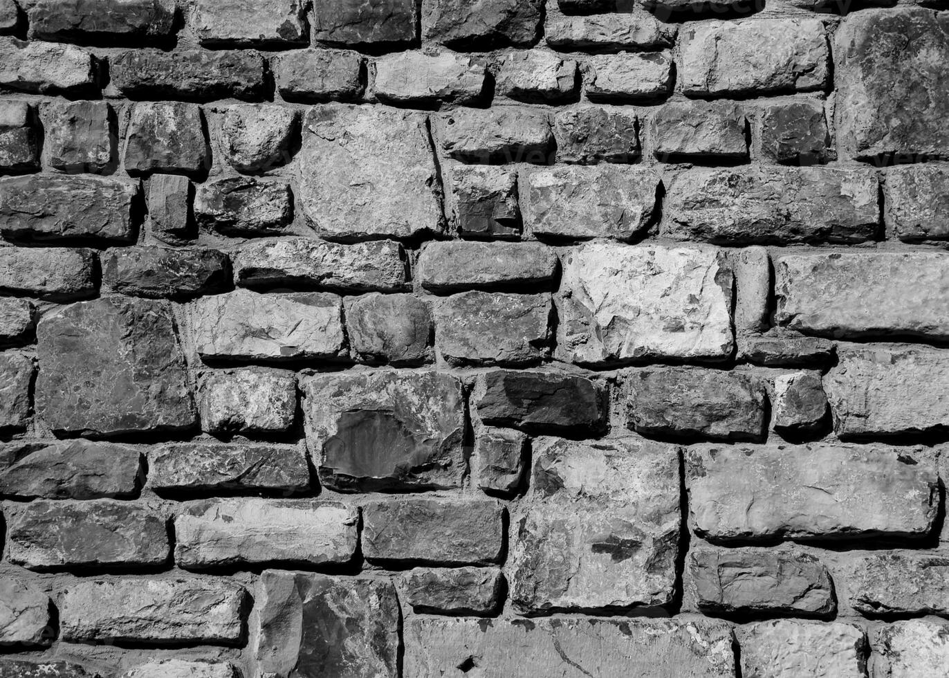 struttura di un muro di pietra. fondo di struttura del muro di pietra del vecchio castello. muro di pietra come sfondo o texture. parte di un muro di pietra, per sfondo o texture foto