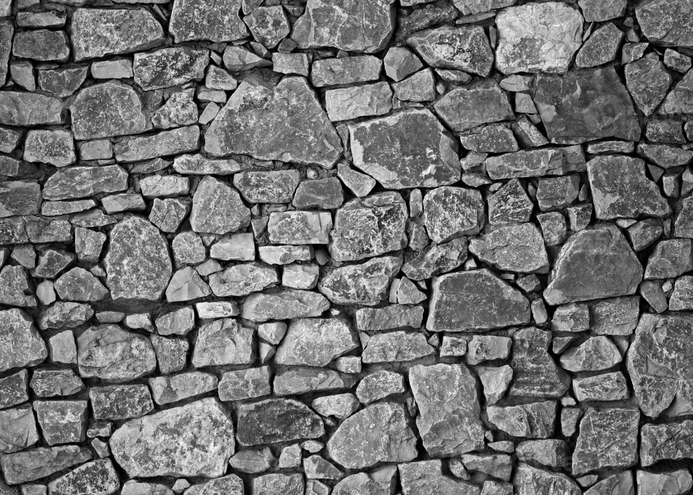 struttura di un muro di pietra. fondo di struttura del muro di pietra del vecchio castello. muro di pietra come sfondo o texture. parte di un muro di pietra, per sfondo o texture foto