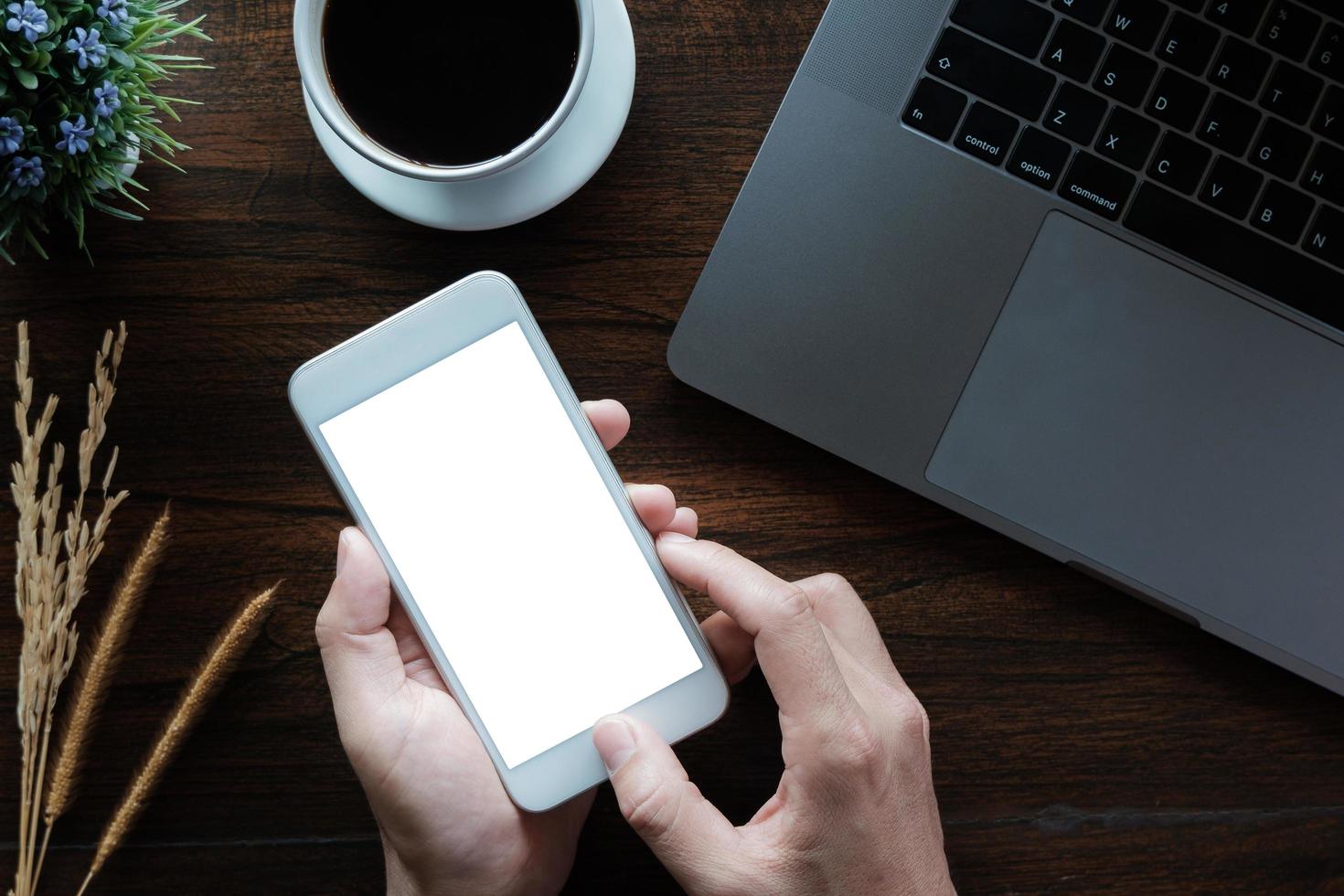 donna d'affari utilizzando smartphone con il computer portatile nel negozio di caffee. smart phone o cellulare con schermo vuoto e può essere aggiunto i tuoi testi o altri, concetto di tecnologia. foto