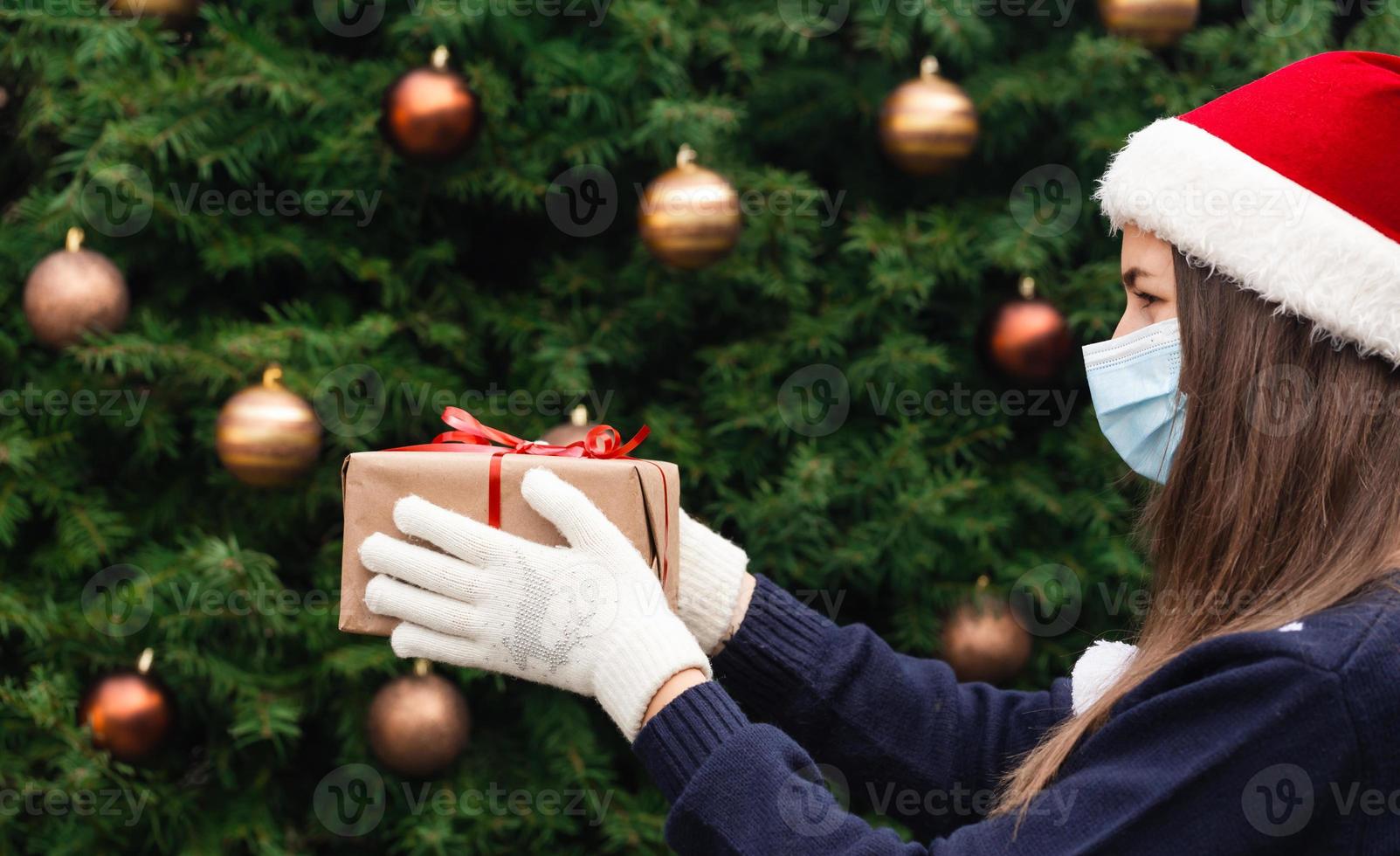 ritratto di una donna che indossa santa cappello e maglione blu nella mascherina medica foto