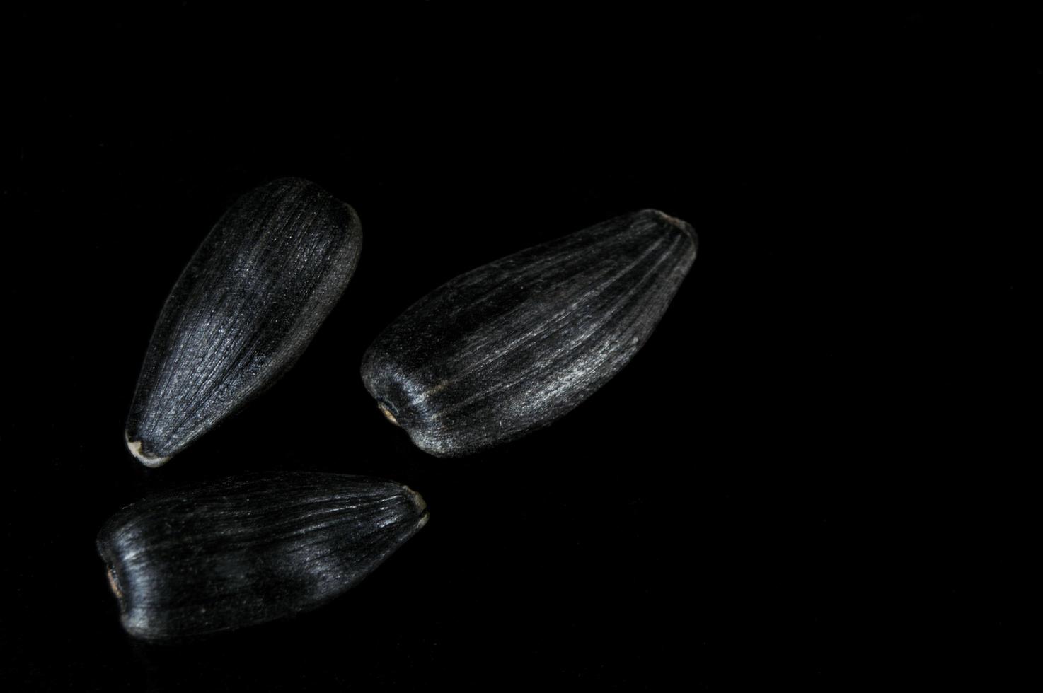 semi di girasole in macro su sfondo nero foto