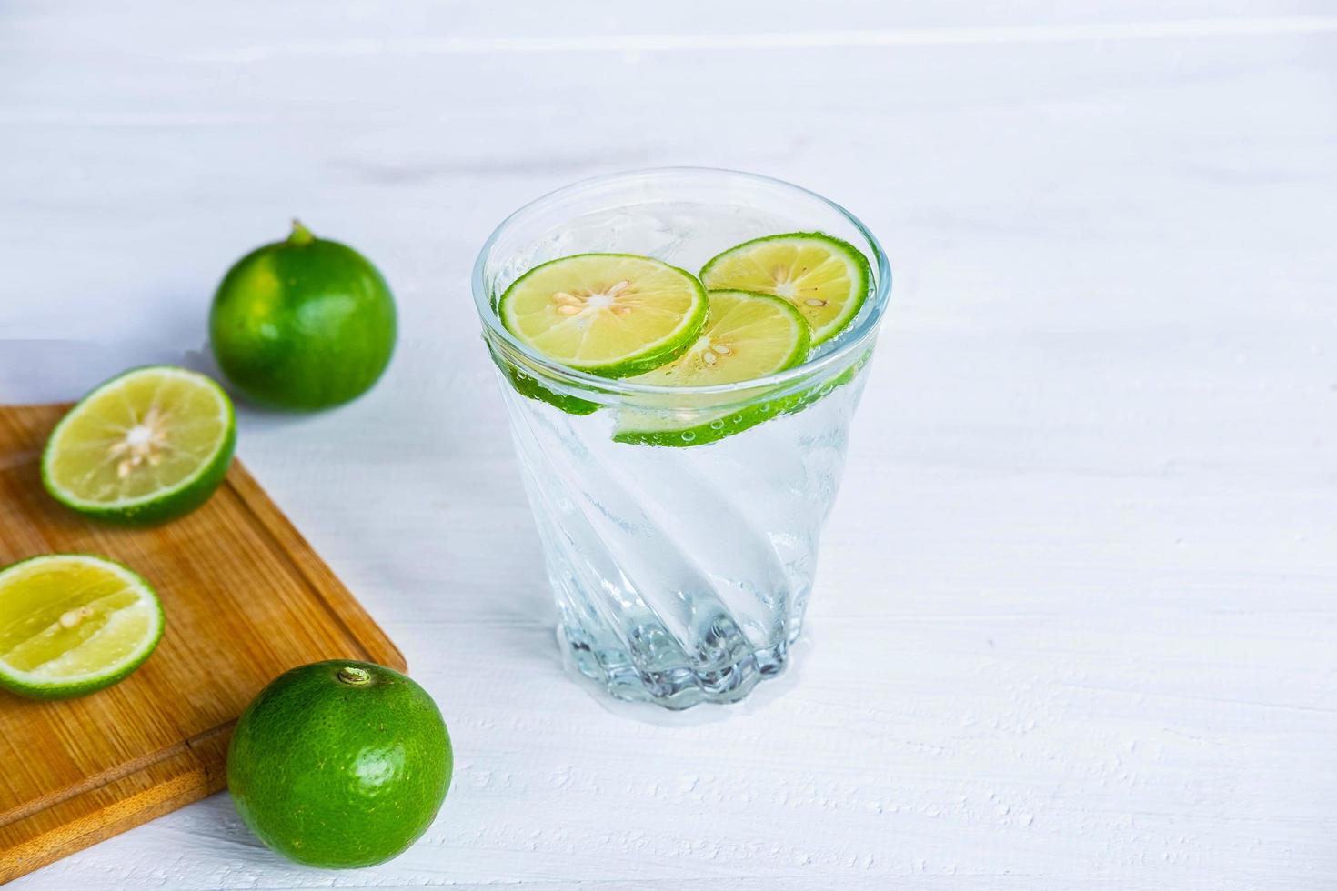 un bicchiere di soda, limone e lime sul tavolo foto