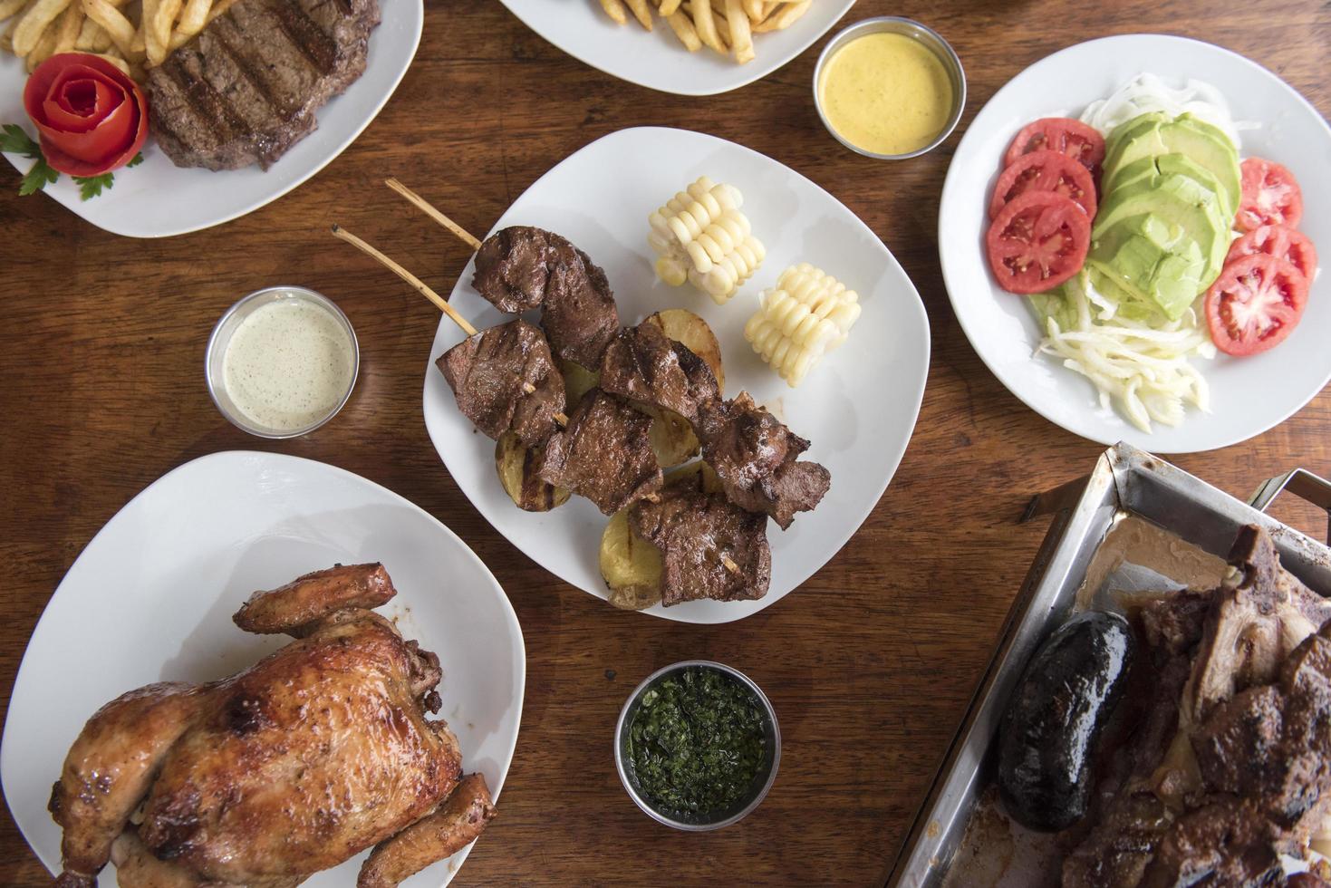 anticuchos cucina peruviana carne di cuore di manzo alla griglia allo spiedo con patate lesse e mais bianco foto