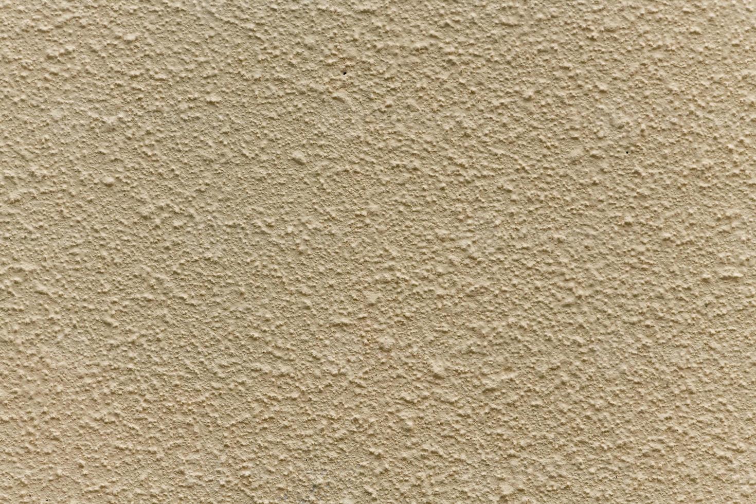 muro di casa intonacato ruvido beige brillante come sfondo foto