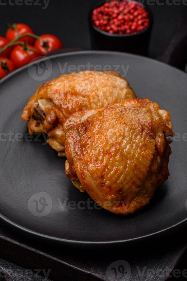 delizioso succoso pollo cosce al forno con sale, spezie e erbe aromatiche nel un' ceramica piatto foto