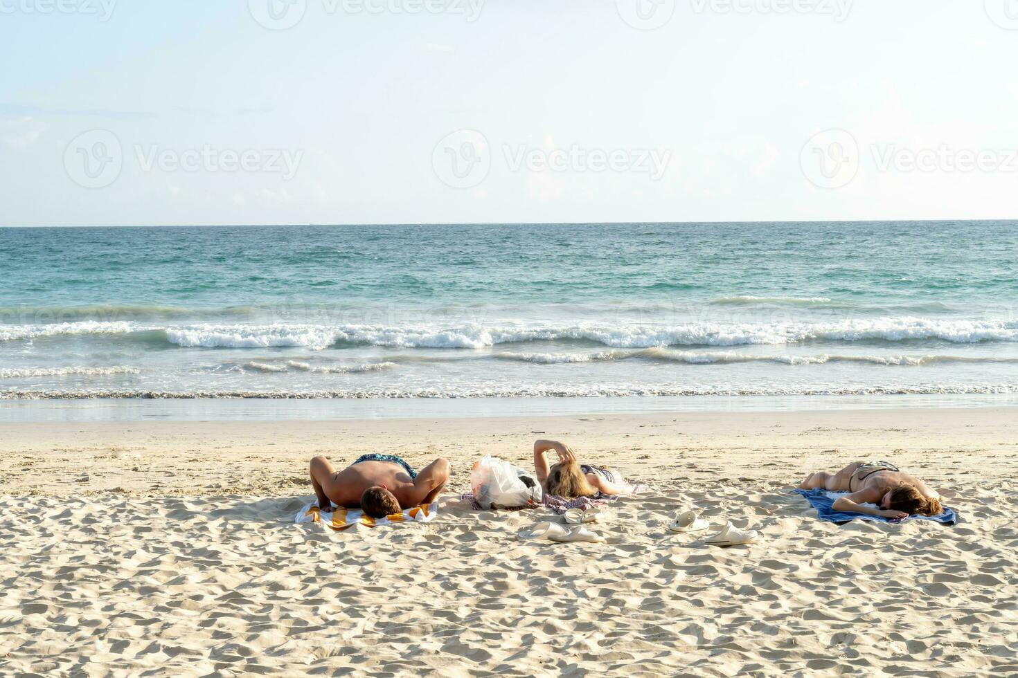 non identificato turisti dire bugie giù per godere prendere il sole a karon spiaggia nel Phuket di Tailandia. foto