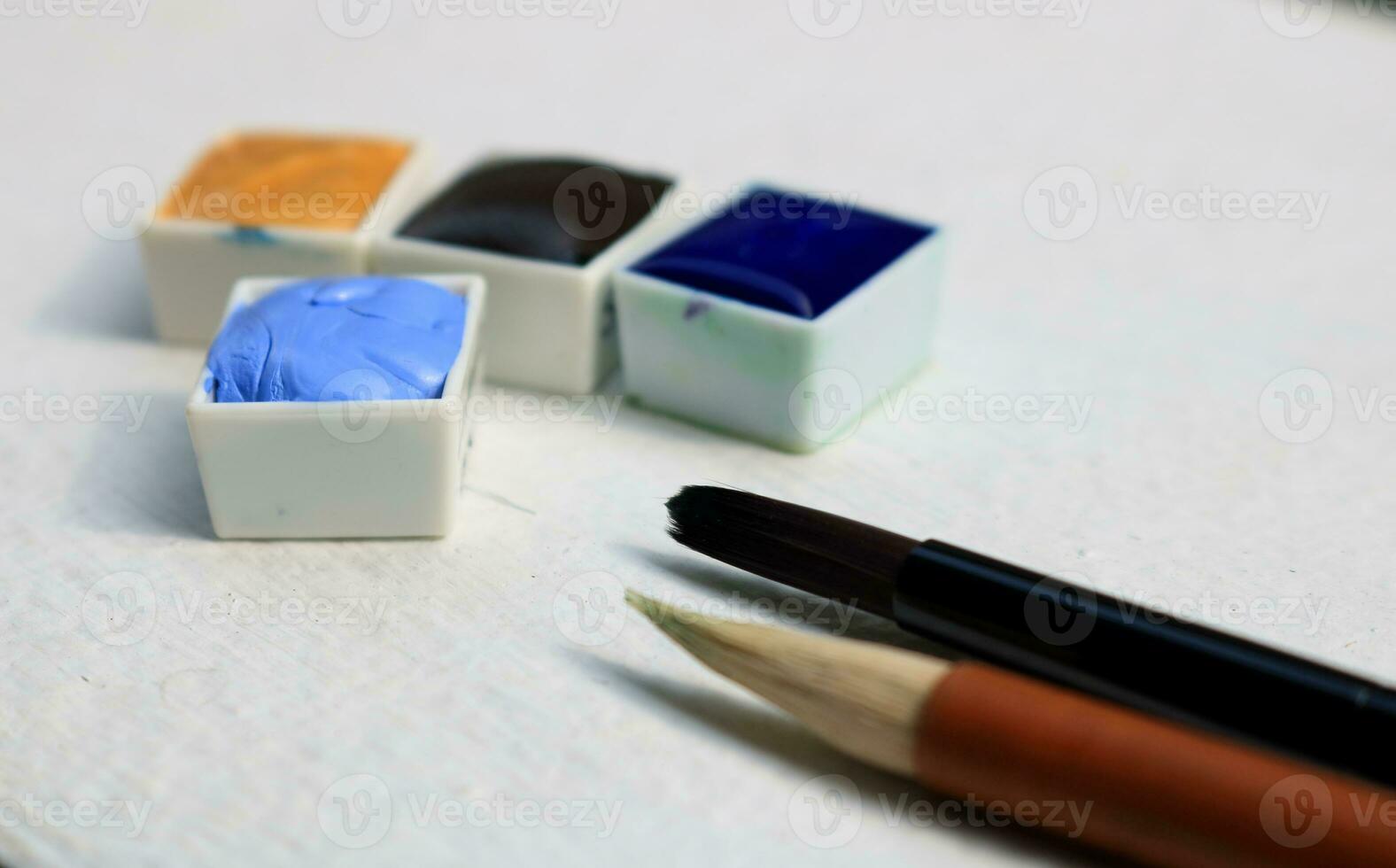 blu acquerello e un altro colore nel bianca plastica pentole su bianca pavimento. foto
