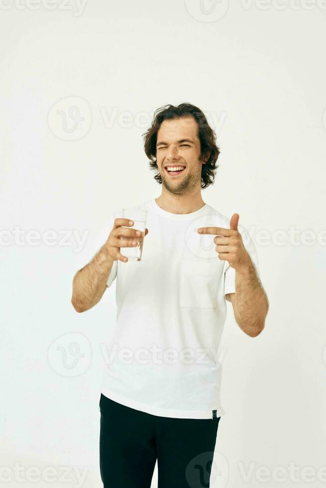 attraente uomo bicchiere di acqua nel il suo mani emozioni in posa isolato sfondo foto