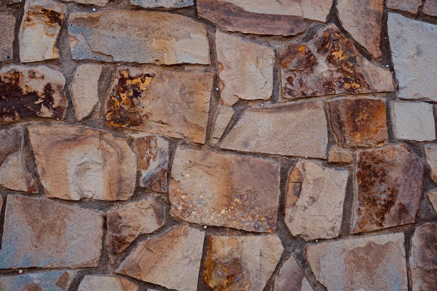 fondo strutturato della parete di pietra rossa foto