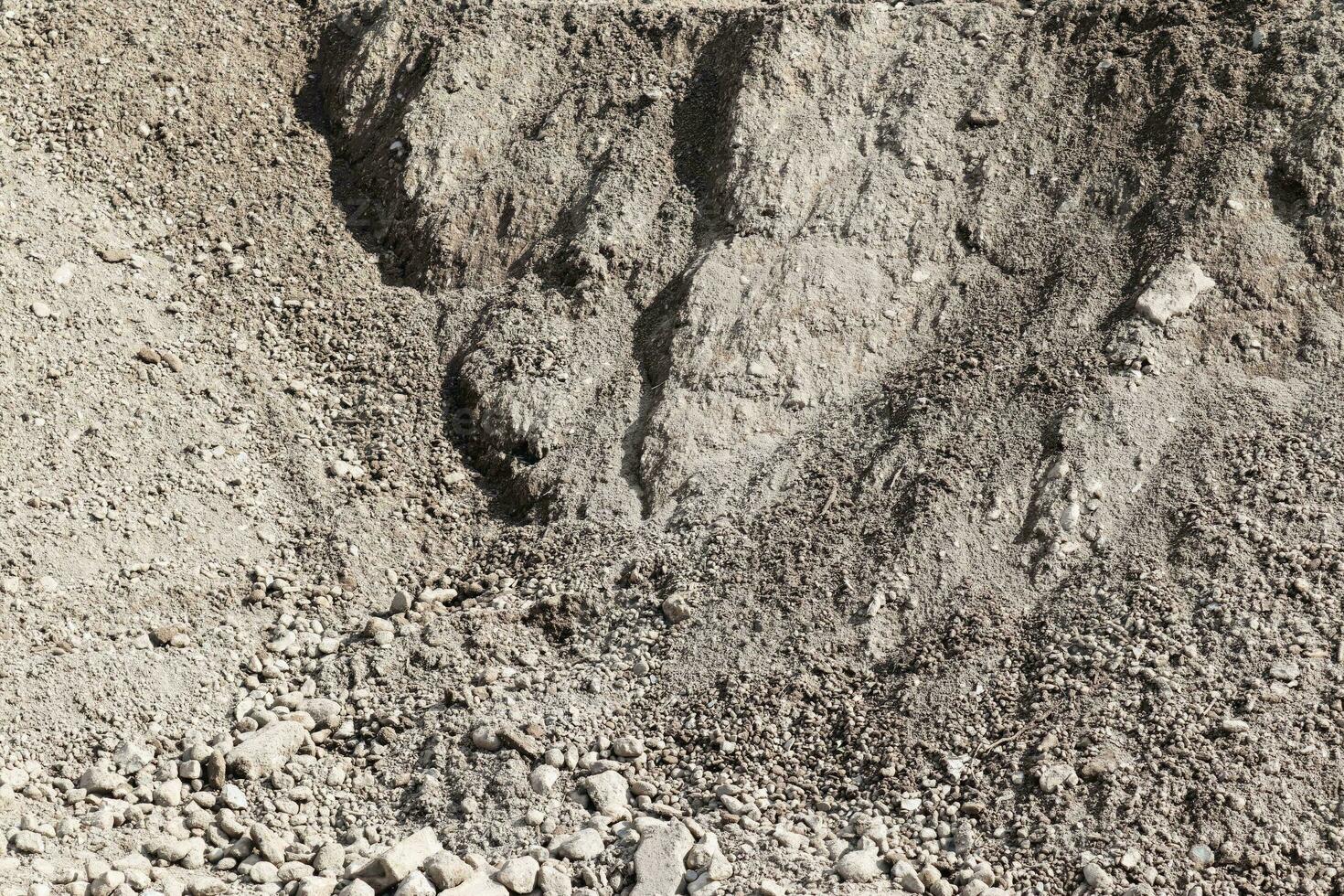 sabbia e pietre su un' ghiaia terra struttura nel alto risoluzione. foto