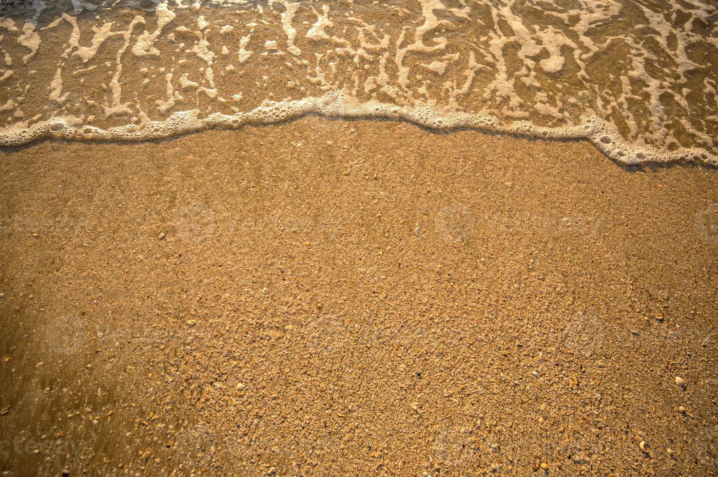 l'angolo superiore della spiaggia ha un mare d'acqua che arriva a riva foto