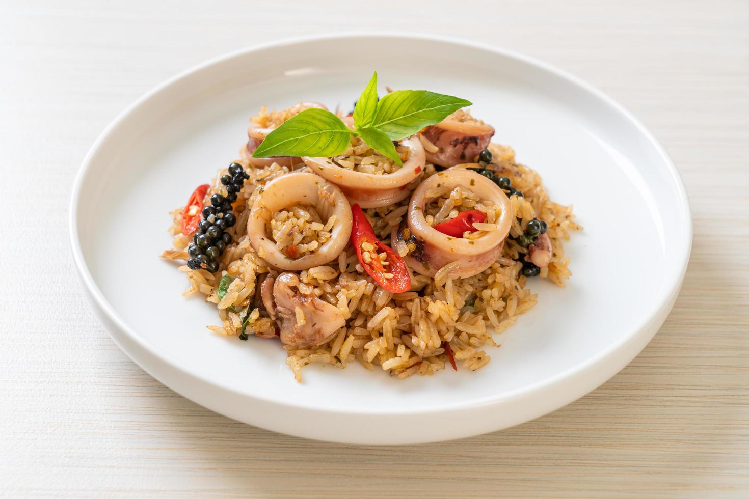 Riso fritto fatto in casa con basilico e erbe piccanti con calamari o polpo - stile asiatico foto