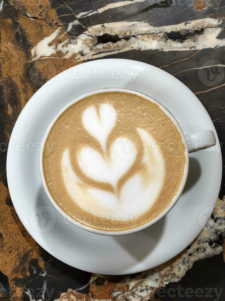 caffè. fermentato cappuccino. cappuccino nel bianca tazza su marmo tavolo foto