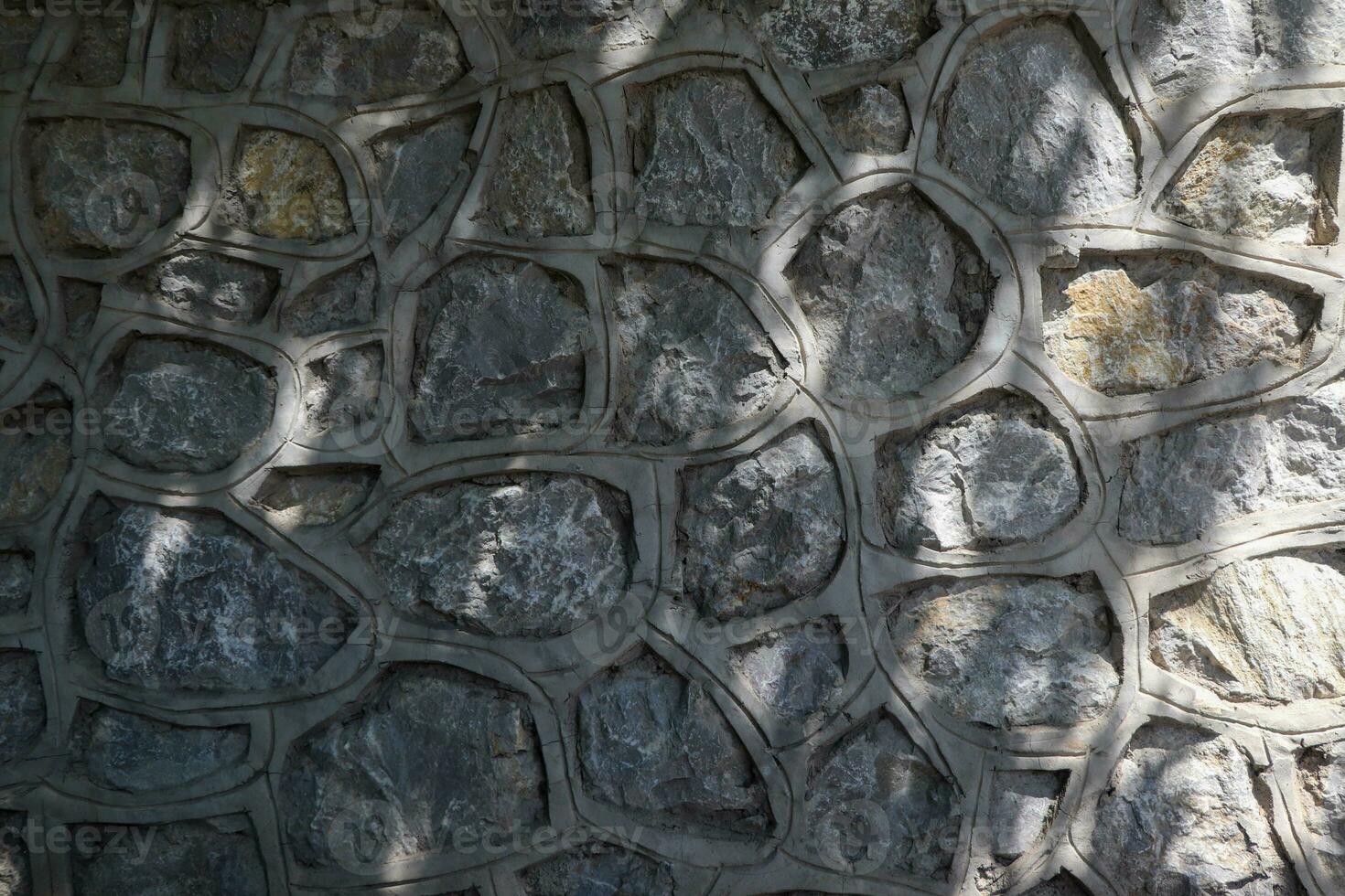 pietroso struttura di grigio Cracked parete foto
