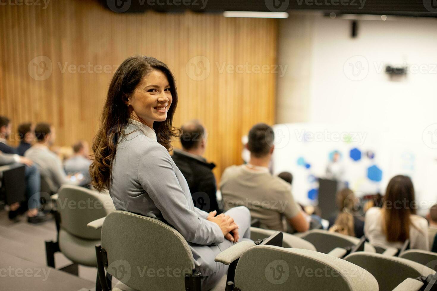 giovane donna seduta nel pubblico su conferenza o laboratorio foto