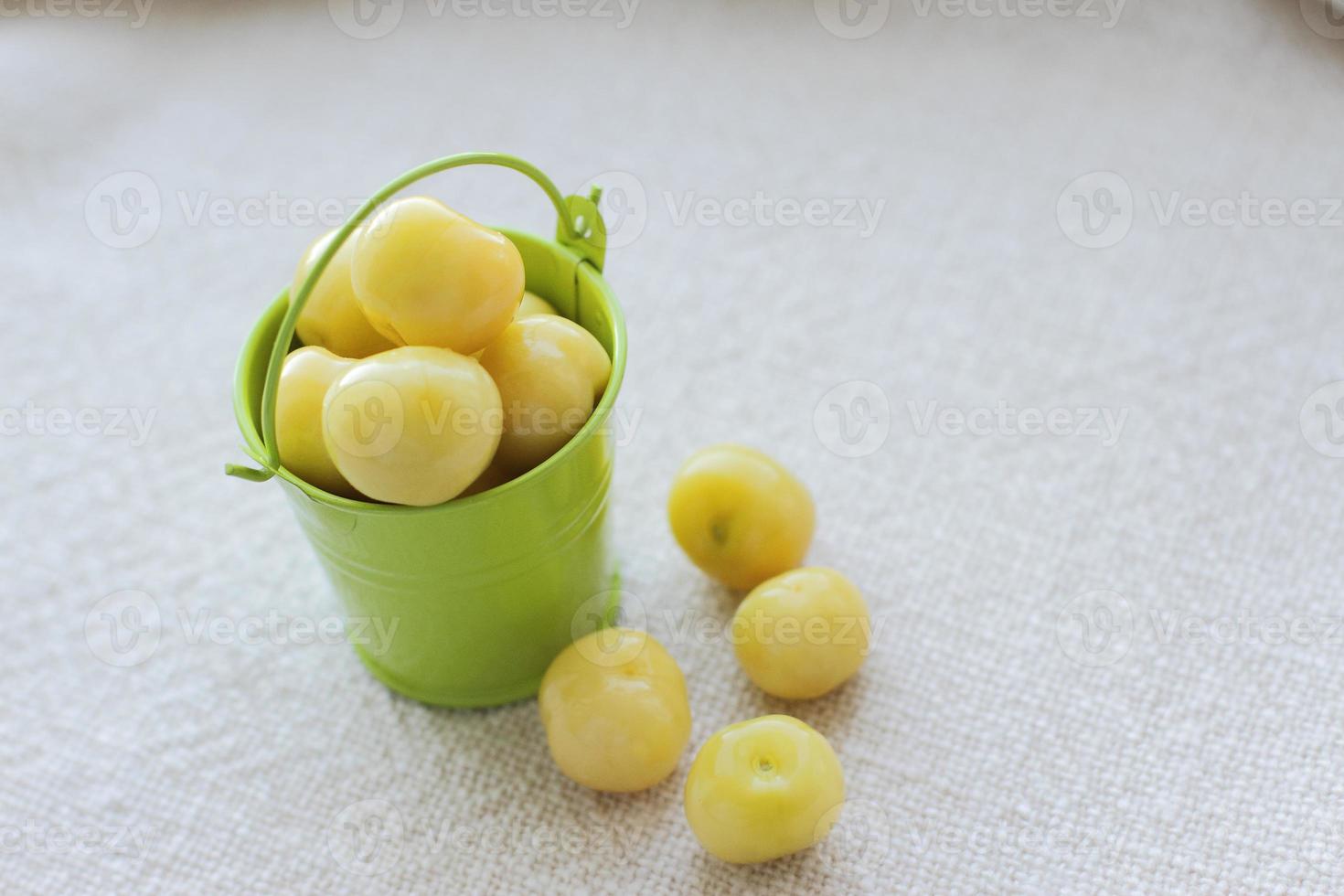 dolci ciliegie fresche in un piccolo secchio verde per il testo foto