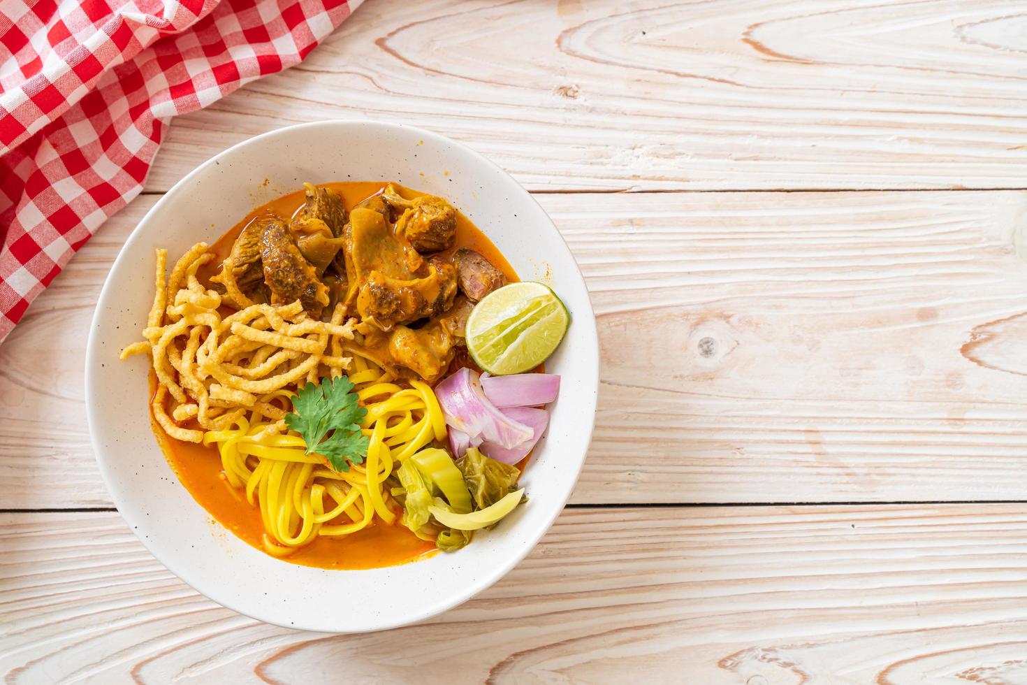 zuppa di noodle al curry del nord della Thailandia con maiale brasato foto