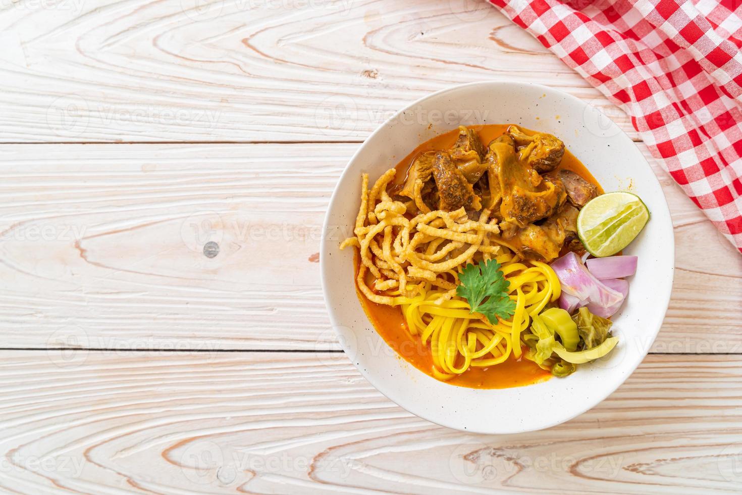 zuppa di noodle al curry del nord della Thailandia con maiale brasato foto