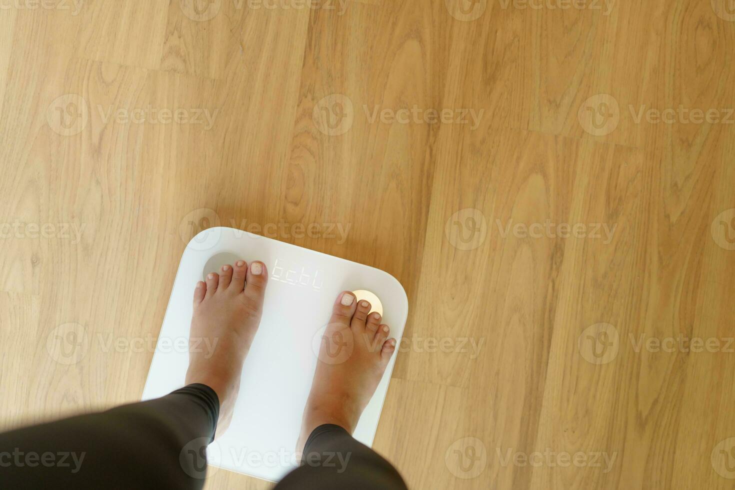 perdere il peso. Grasso dieta e scala piedi in piedi su elettronico bilancia per peso controllo. misurazione strumento nel chilogrammo per dieta. foto