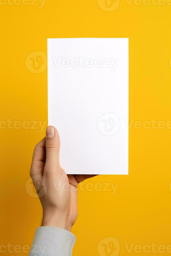 un' umano mano Tenere un' vuoto foglio di bianca carta o carta isolato su giallo sfondo. ai generato foto