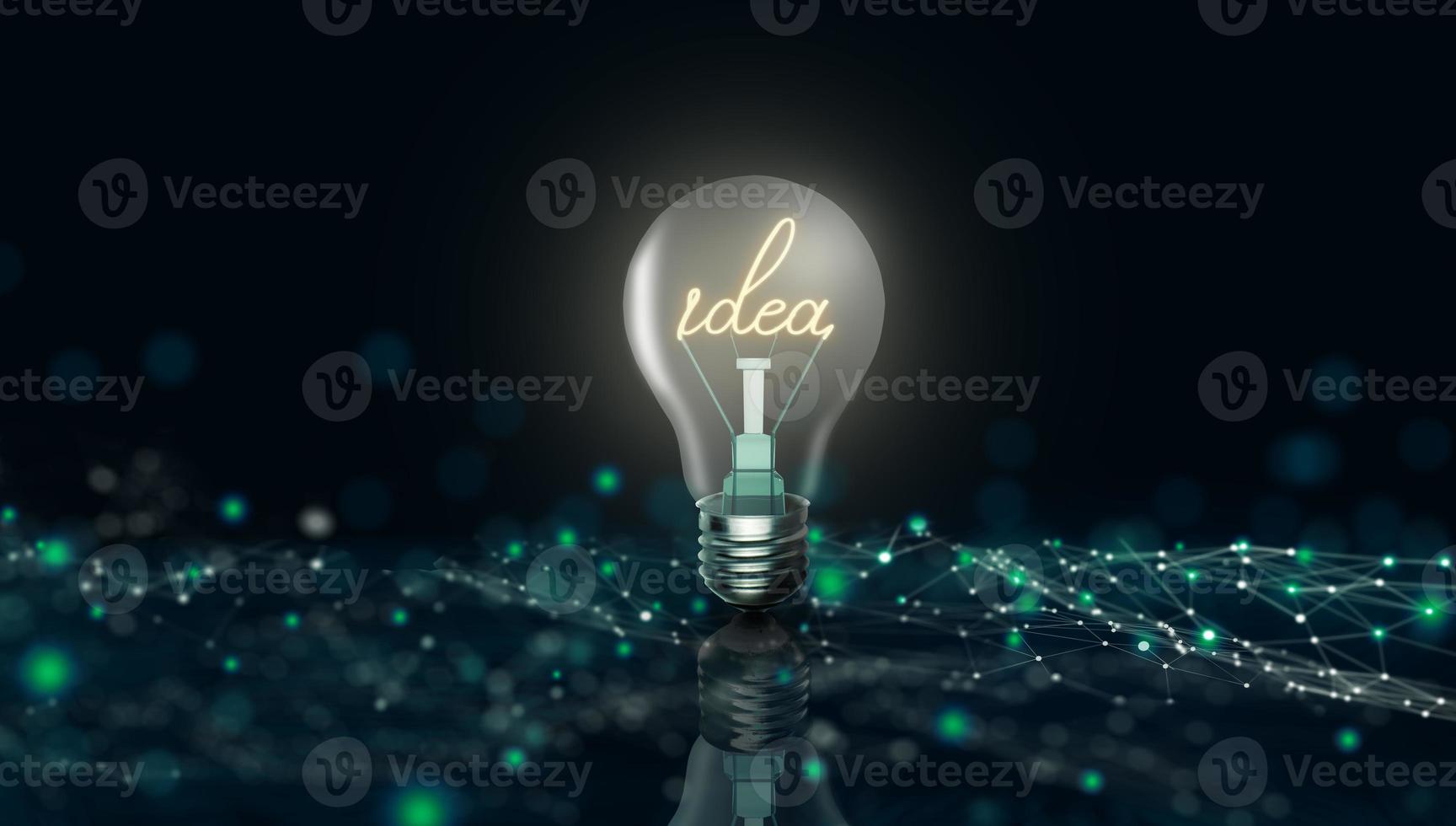 lampadina incandescente con la parola idea sullo sfondo della tecnologia aziendale digitale foto