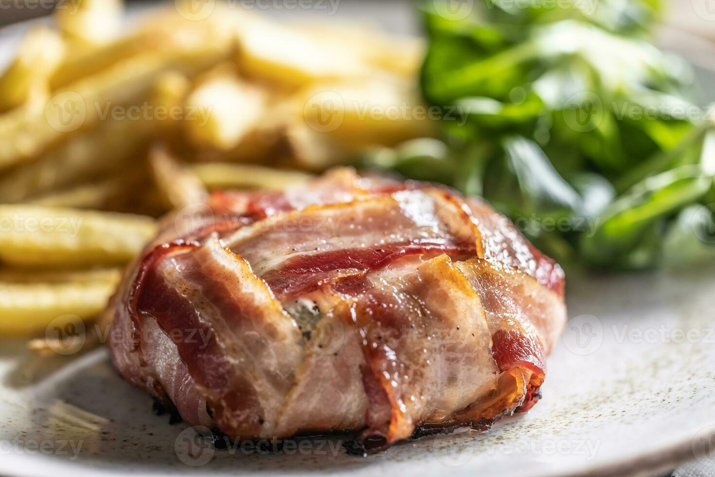 succoso e croccante il giro formaggio e Bacon avvolgere servito con patatine fritte e insalata su il lato foto