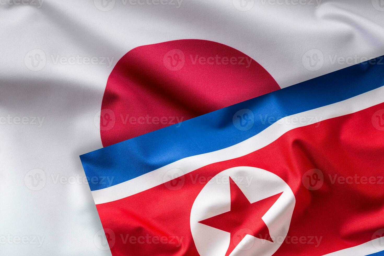 Giappone e nord Corea bandiera. colorato Giappone e nord Corea bandiera agitando nel il vento foto