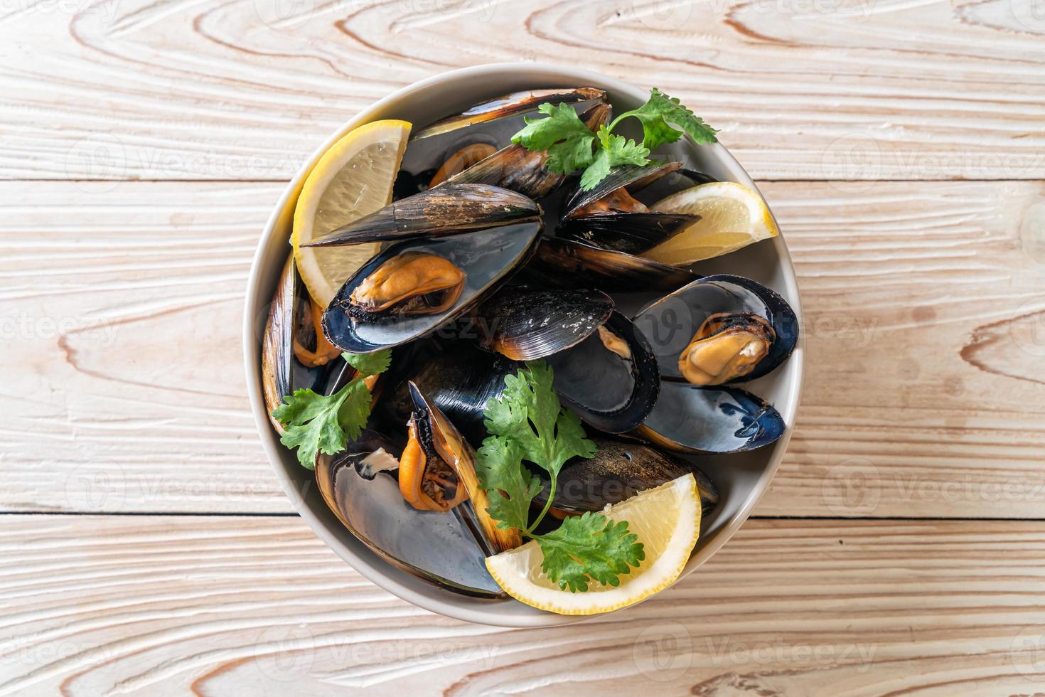 cozze alle erbe in una ciotola al limone foto