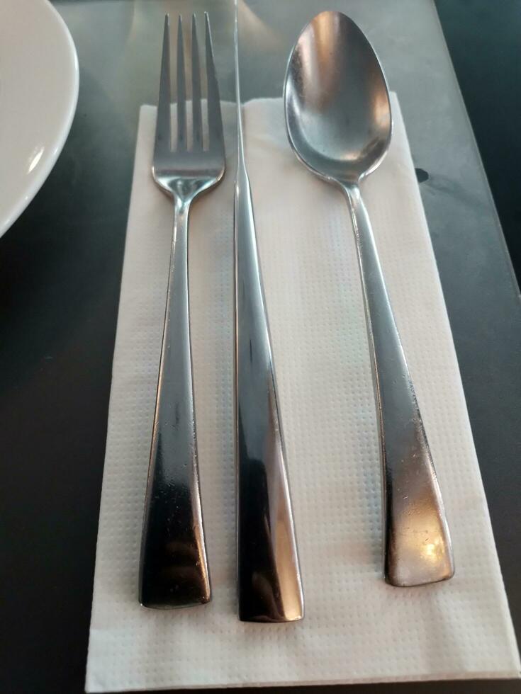 cucchiai e forchette su il cenare tavolo foto