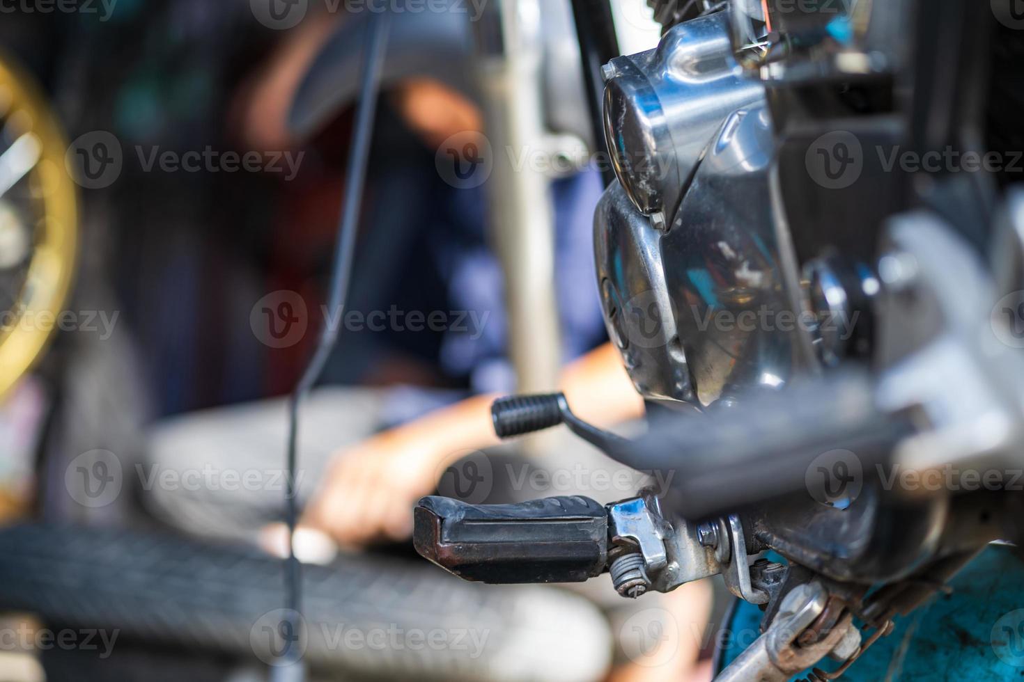 meccanico di automobili che ripara motocicletta in un'officina di riparazione di biciclette foto