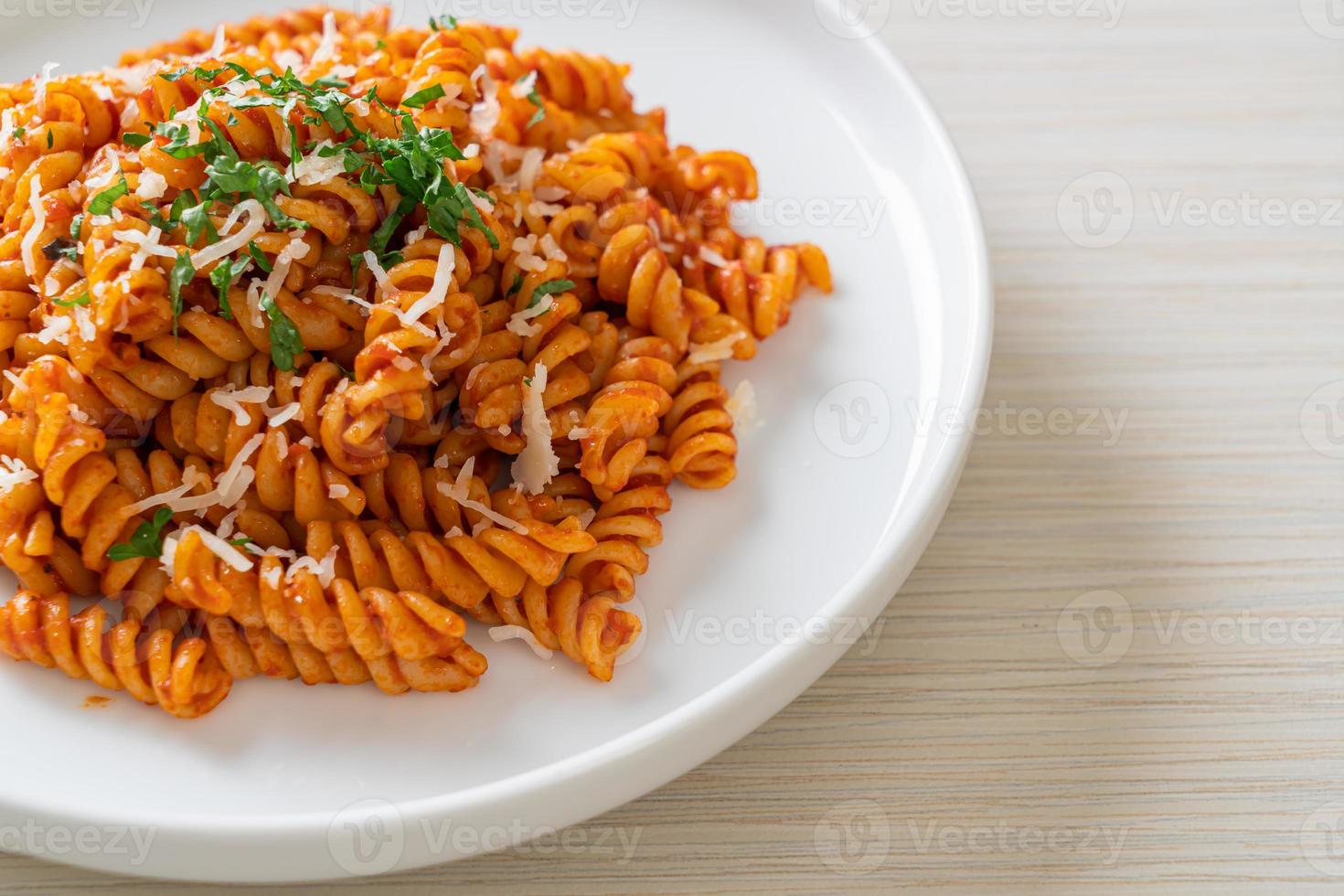 pasta a spirale o spirali con salsa di pomodoro e salsiccia - stile italiano foto