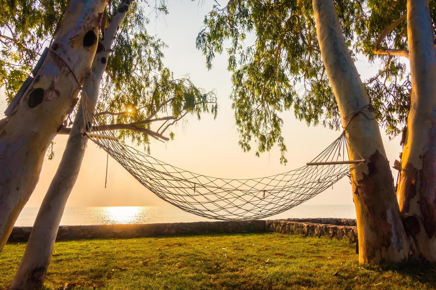 amaca vicino alla spiaggia e al mare all'alba foto