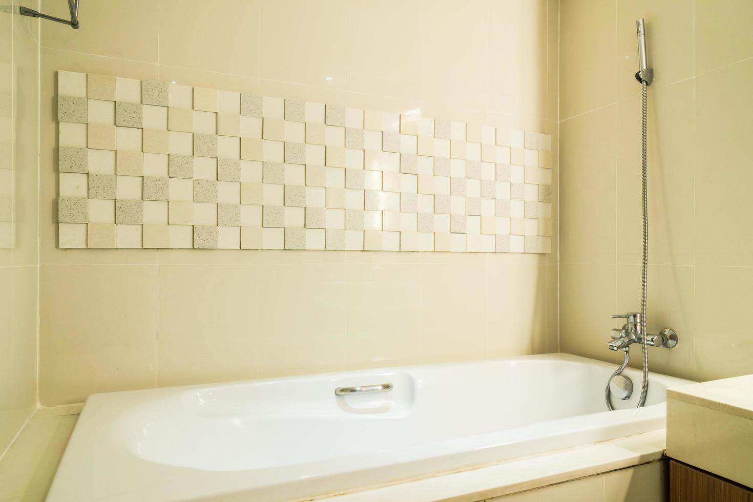 lavello bianco e rubinetto e decorazione della vasca da bagno in bagno foto