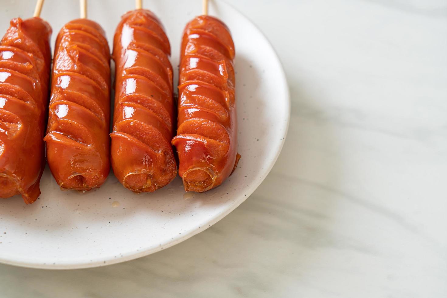 spiedino di salsiccia fritta su piatto bianco foto