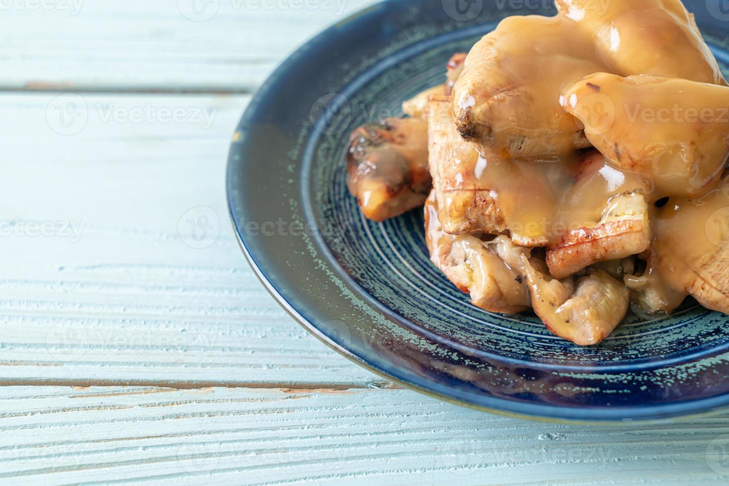 banane grigliate con salsa al caramello al cocco sul piatto foto