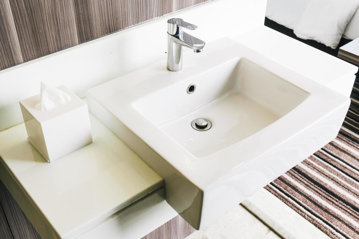 lavabo moderno bianco e rubinetto in bagno foto