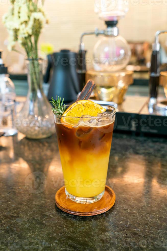 aranciata e limone soda condita con caffè nero in vetro con rosmarino e cannella foto