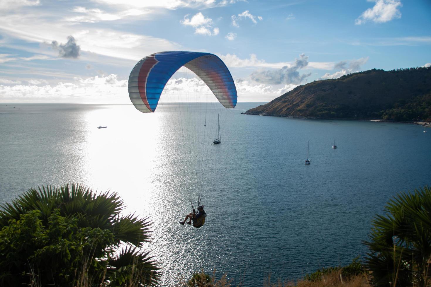 parapendio sul mare con un bellissimo sfondo azzurro del cielo a phuket, thailandia foto