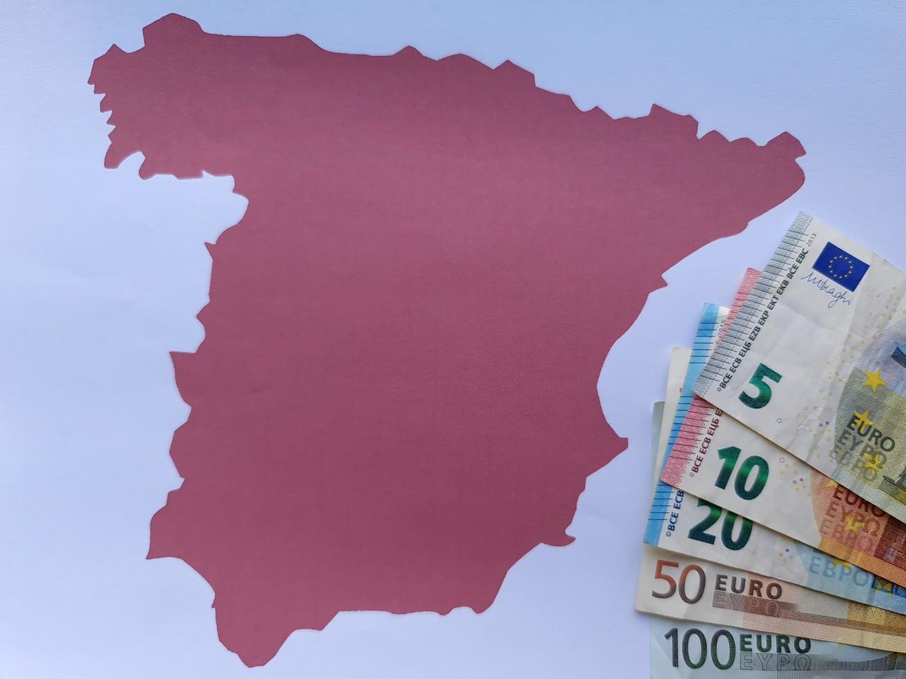 banconote europee e sfondo con silhouette mappa spagna foto