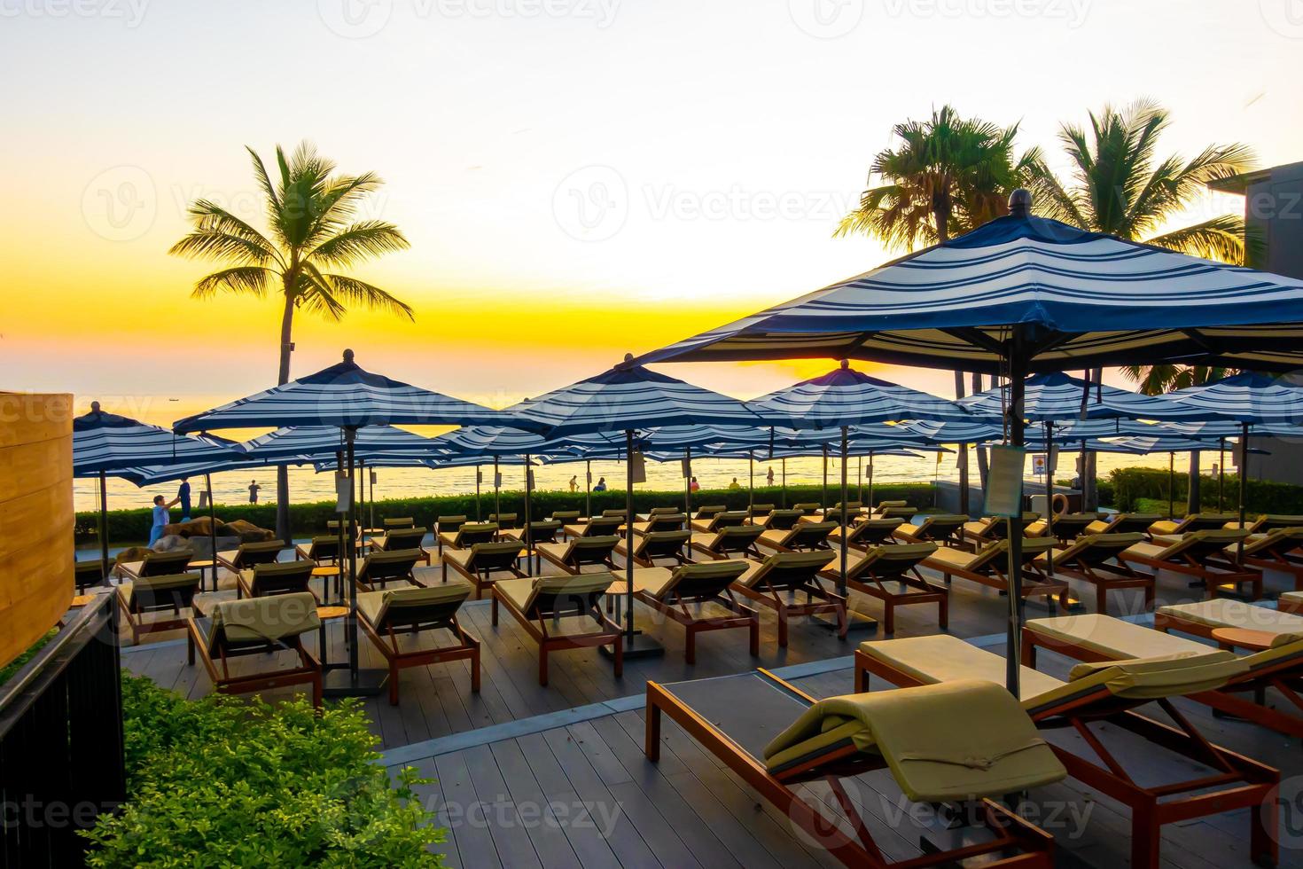 ombrelloni e sedie intorno alla piscina all'aperto nel resort dell'hotel per le vacanze in vacanza sfondo di viaggio foto