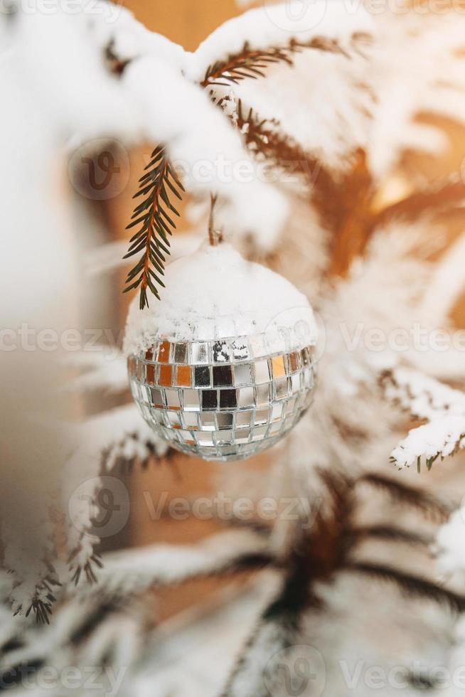 palla a specchio sull'albero del nuovo anno - i giocattoli di Natale decorano l'abete foto
