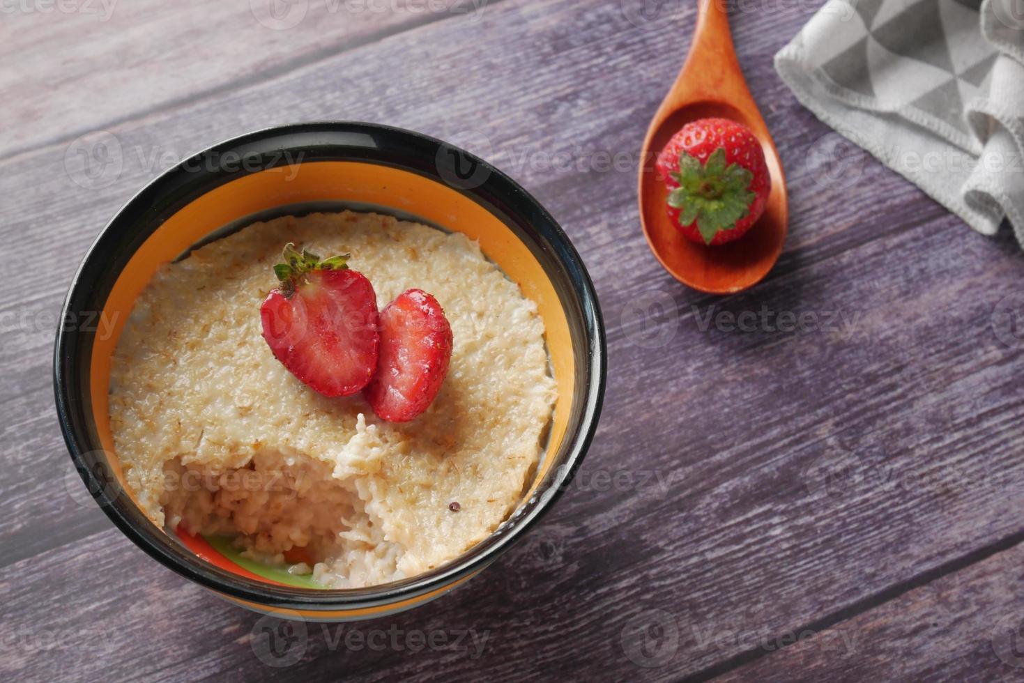 fiocchi d'avena e fragola su tavola di legno foto