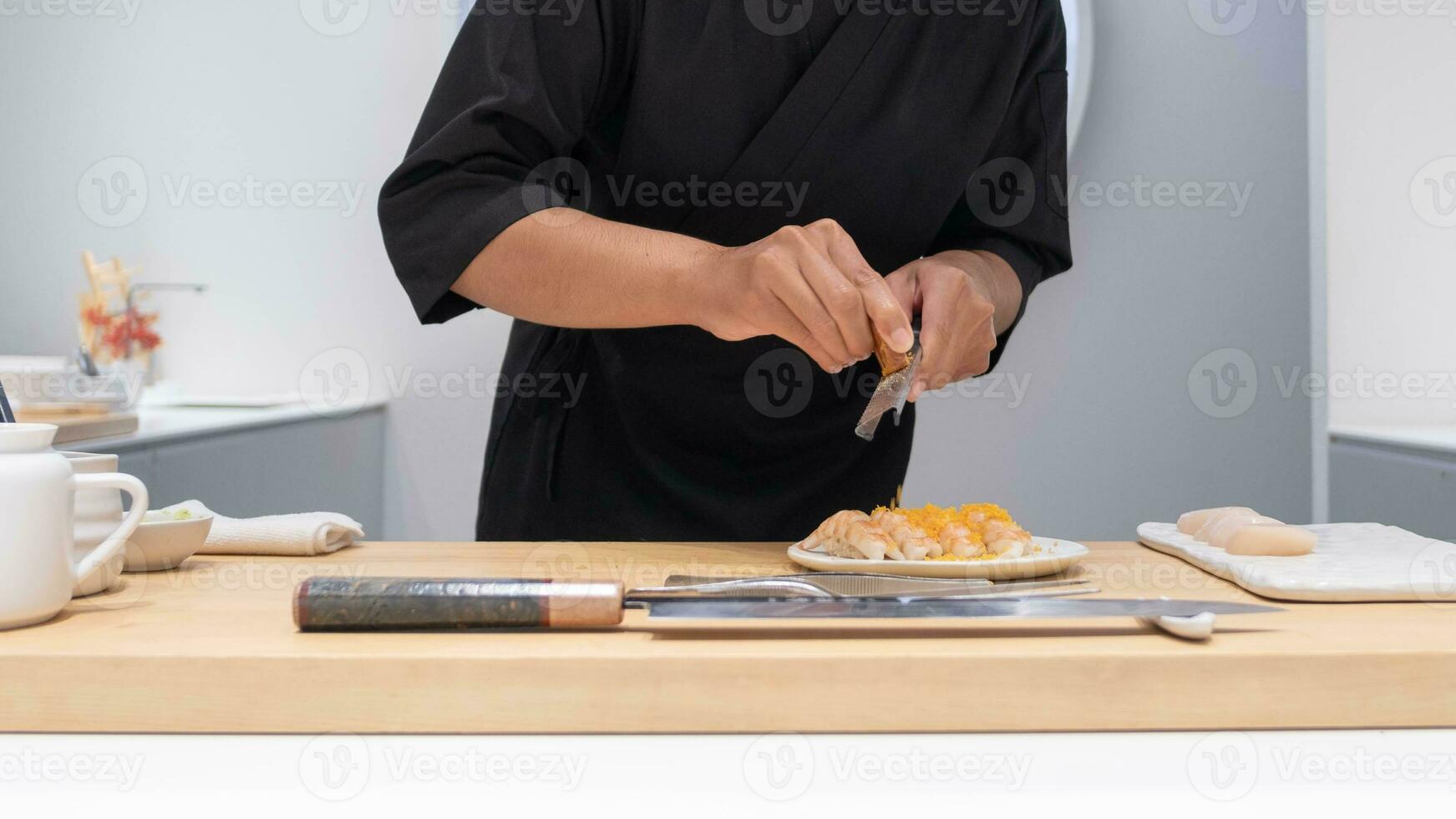 professionale capocuoco preparazione e cucinando crudo fresco pesce ingrediente su il tavolo con coltello per delizioso Sushi e sashimi pasto, persona fabbricazione lusso omakase bene cenare giapponese cibo ristorante cena foto