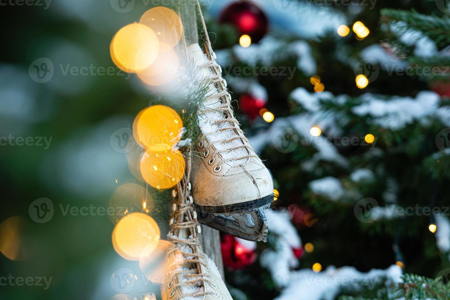 un paio di pattini, albero di natale sfocato sullo sfondo foto