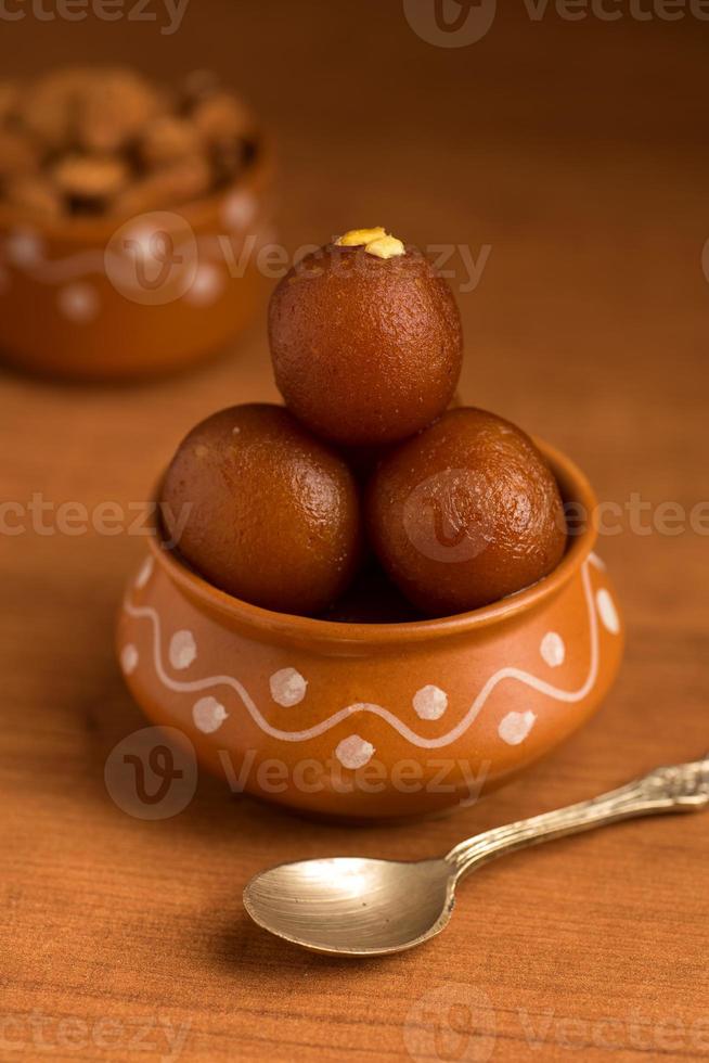 gulab jamun in vaso di terracotta. dessert indiano o piatto dolce foto