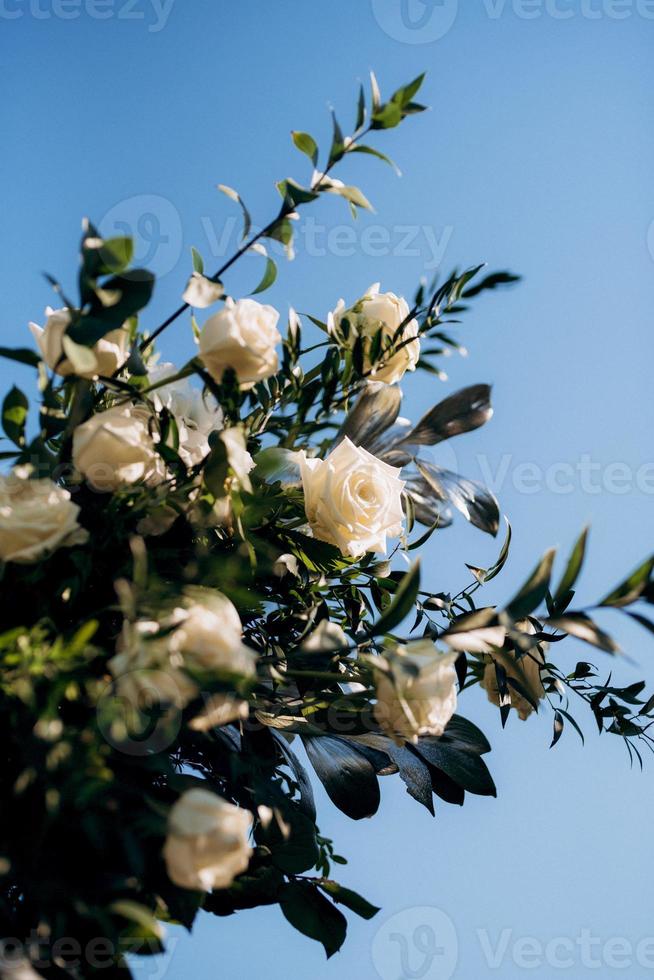 eleganti decorazioni nuziali fatte di fiori naturali ed elementi verdi foto