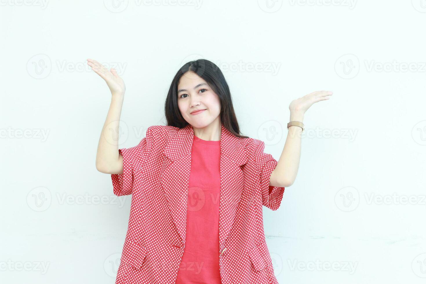ritratto di bellissimo asiatico donna indossare rosso attrezzatura puntamento su per copia spazio con sorridente gesto foto