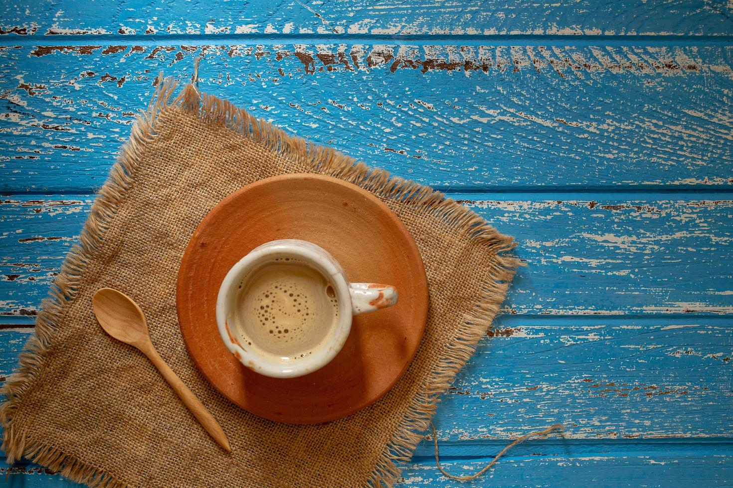 tazza di caffè caldo al mattino su un tavolo di legno rurale blu foto